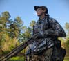 Female hunter wearing turkey hunting vest in the field