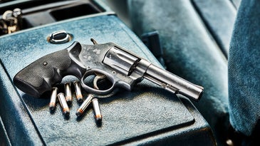Revolver on the center console of a truck.