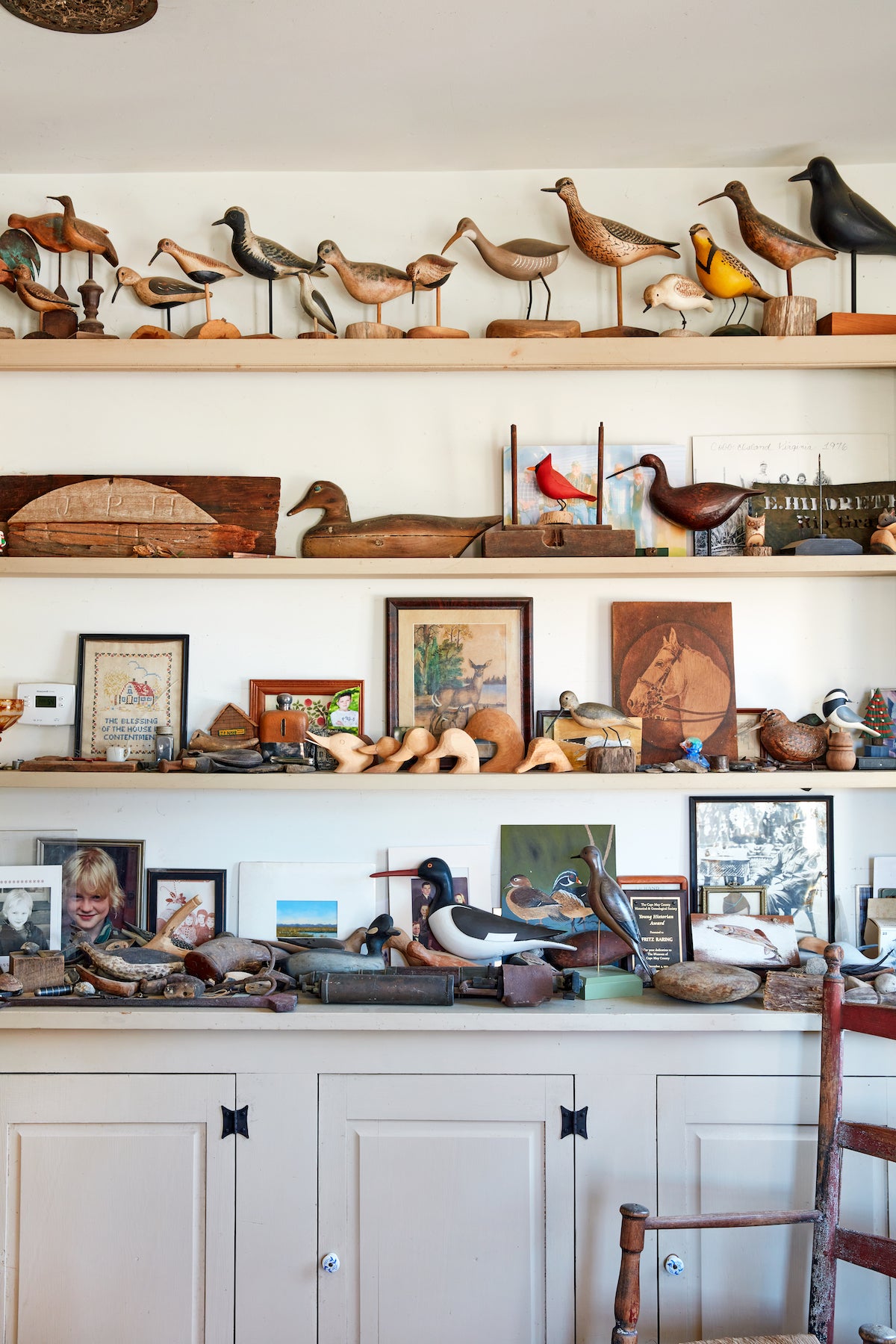 Shelves full of shorebird decoys and antiques.