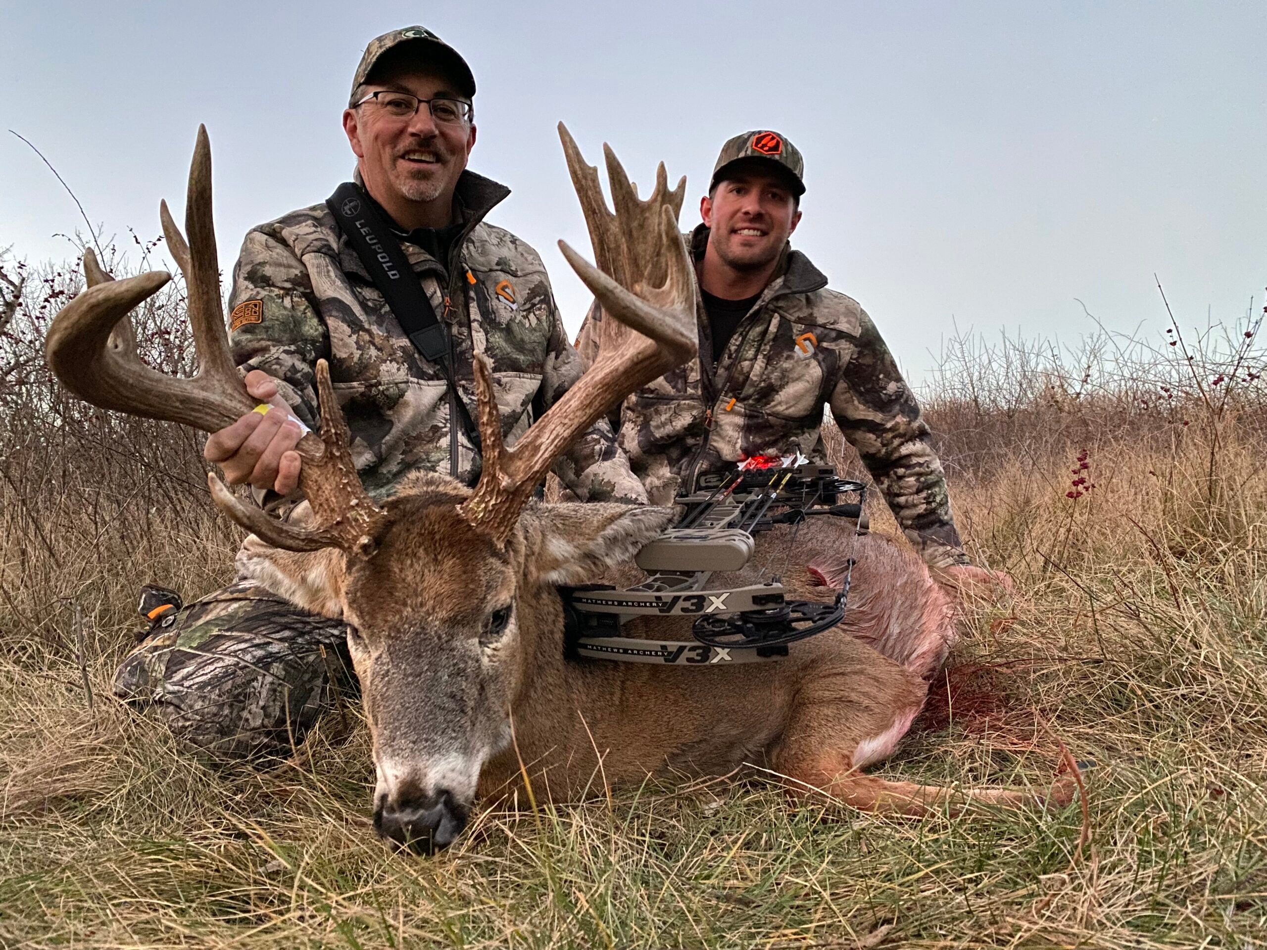 photo of hunter and whitetail buck