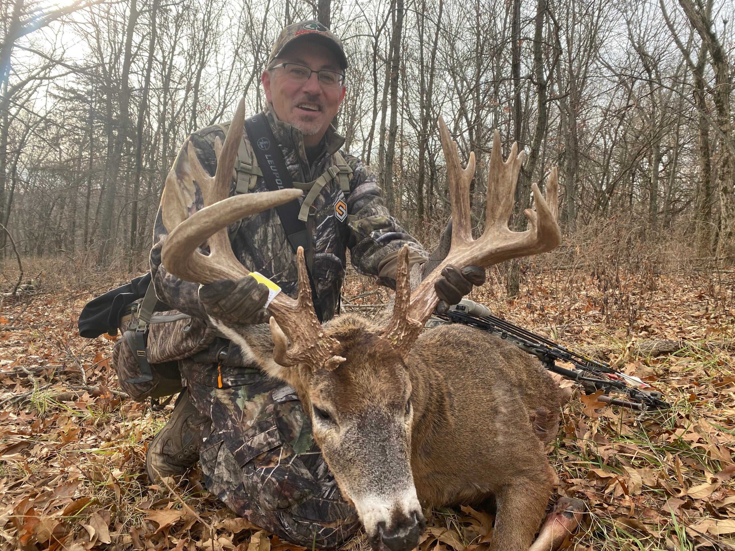 photo of hunter with whitetail buck