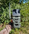 Hunter holding SpyPoint Flex-S cellular trail camera