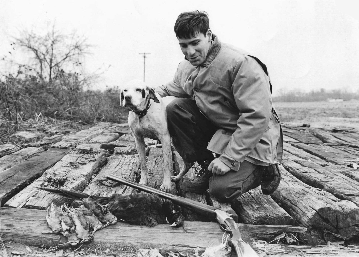 david e. petzal with a pointer hunting dog