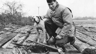 david e. petzal with a pointer hunting dog