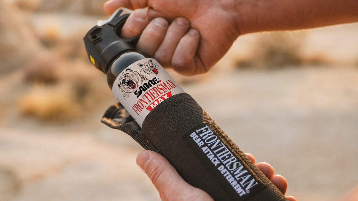 Man holding canister of Frontiersman Bear Spray