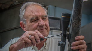 Melvin Forbes working on a rifle.