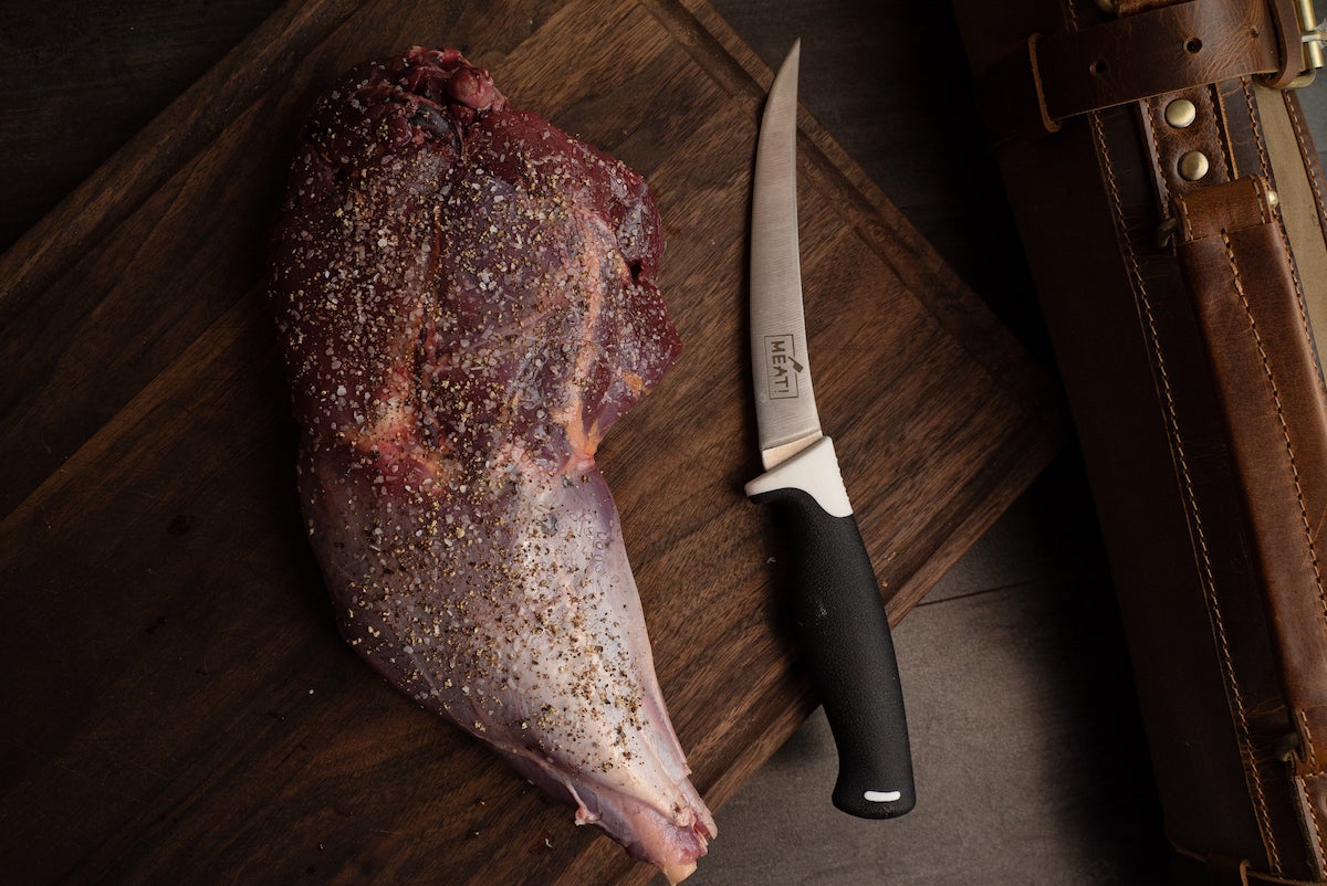 knife next to a wild turkey leg.