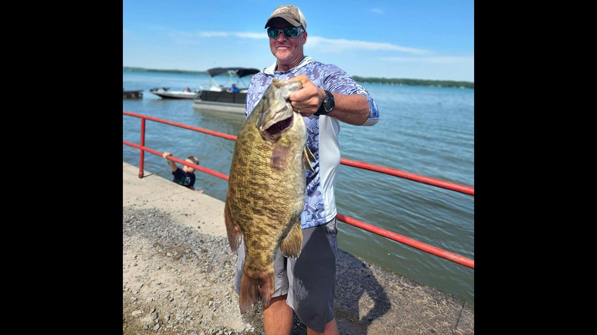 man holds giant smallmouth bass