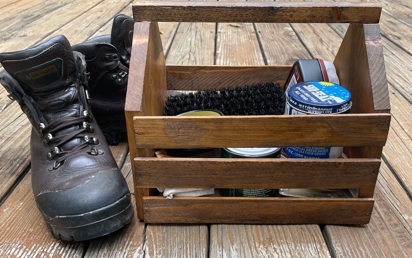 A pair of Vasque boots next to a boot cleaning kit
