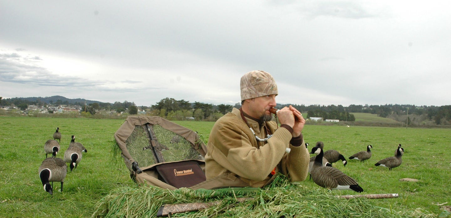 hunter using a goose call