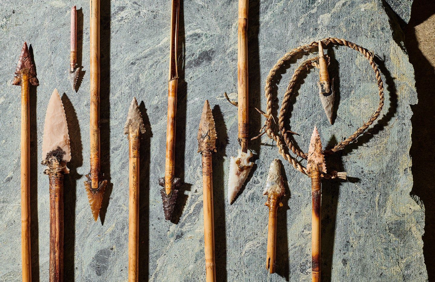 arrowheads and spear points on slate