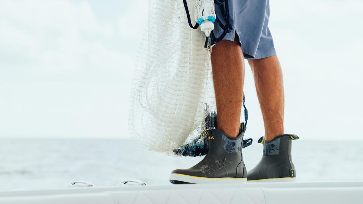 Fisherman wearing Huk Rogue Wave Fishing Boots on boat