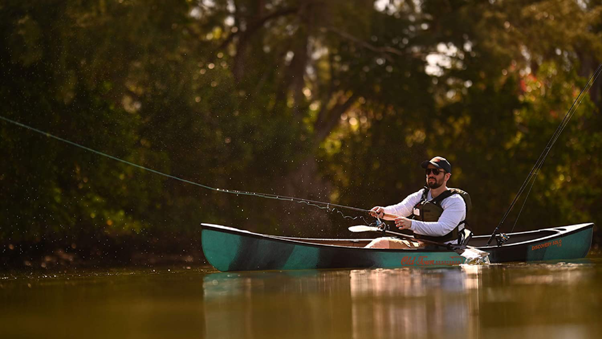 Angler fishing from Old Town Sportsman Discovery Fishing Canoe