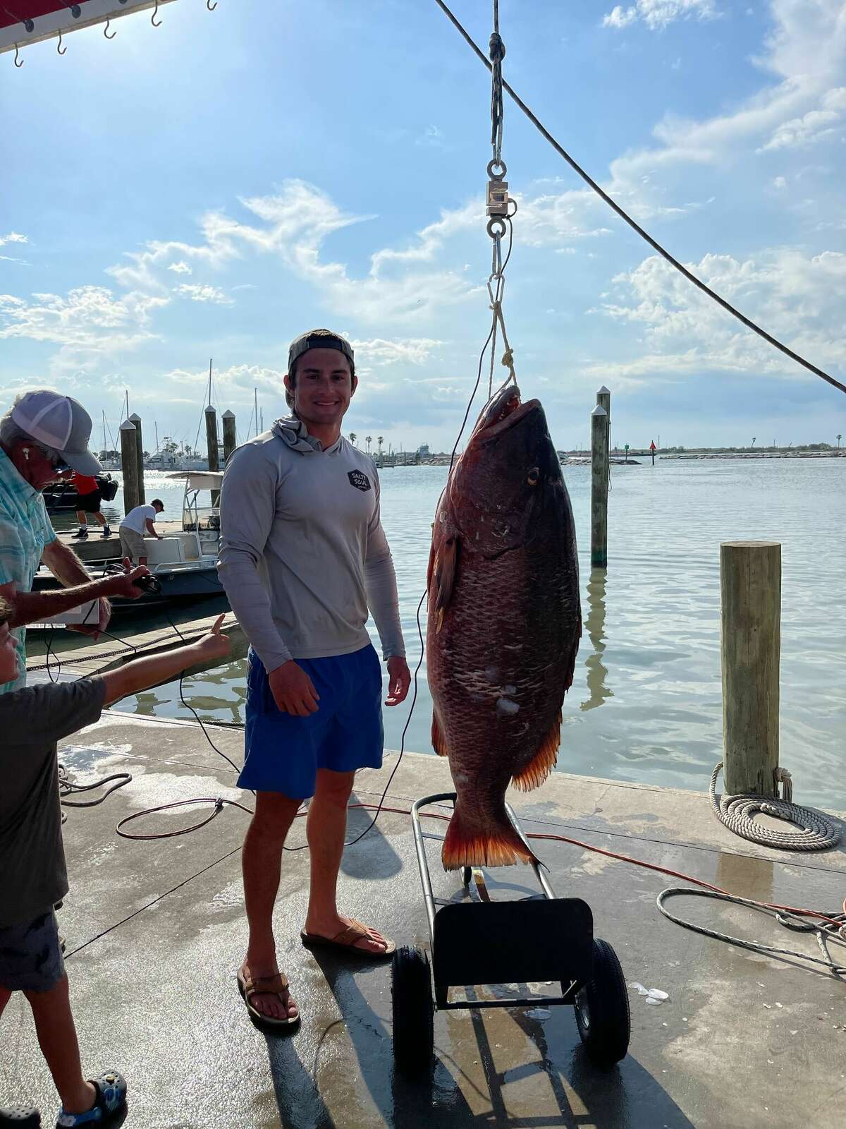 photo of angler and cubera snapper