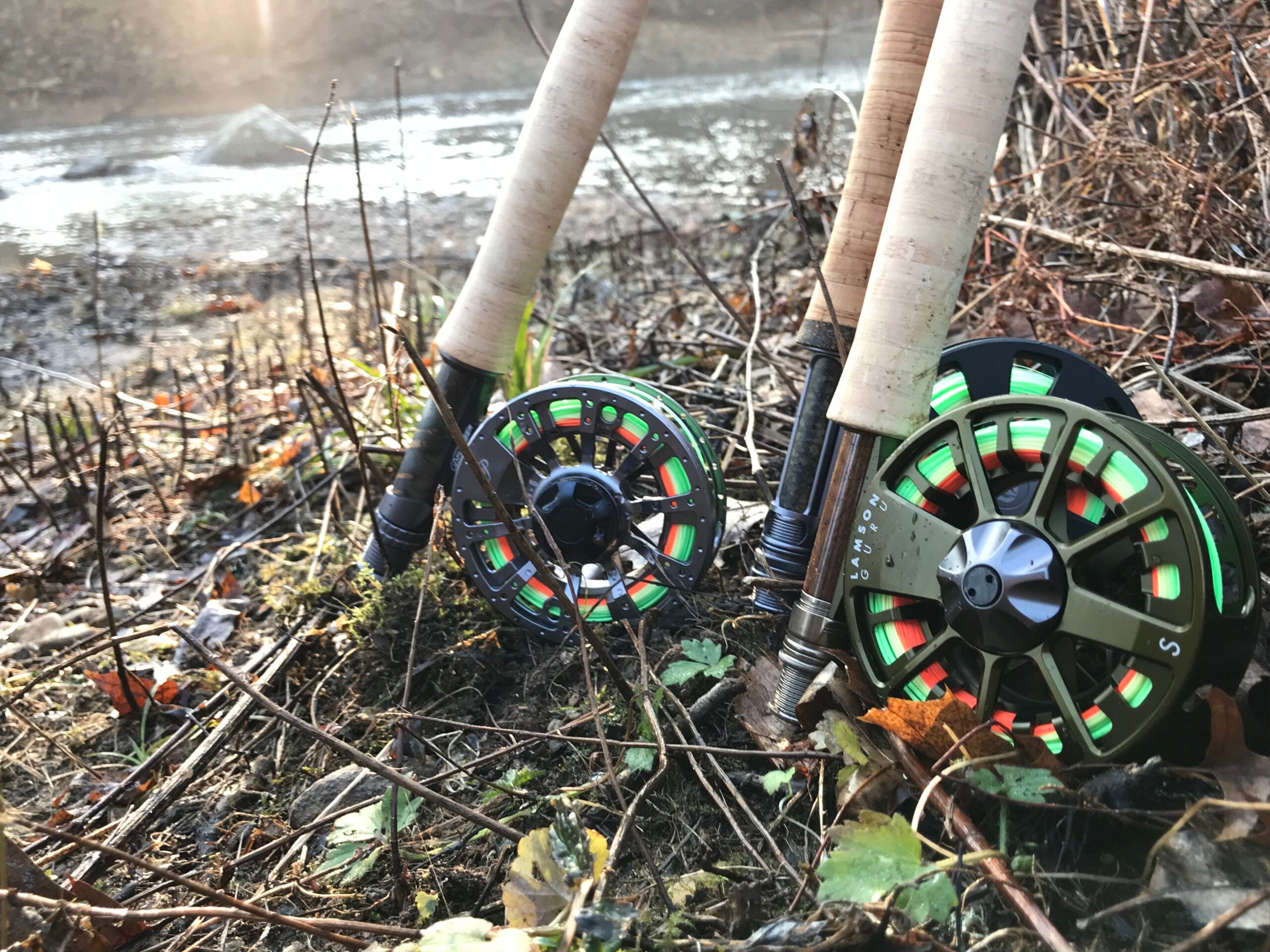 three fly rods along a river