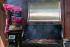 Traeger wood pellets next to a grill, best wood for smoking fish