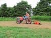 Man riding a tractor in a food plot.