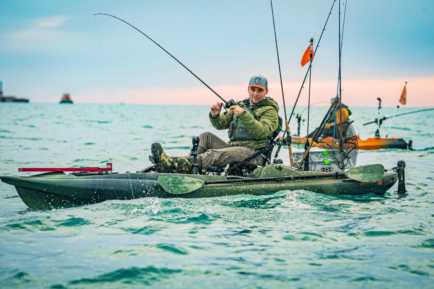 man fishes from kayak in ocean