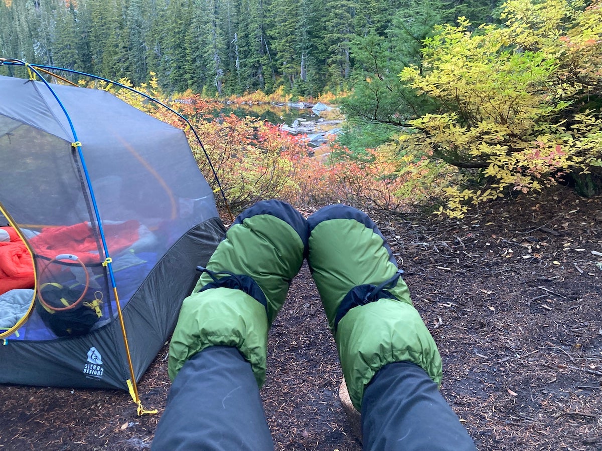 Camper wearing Feathered Friends Down Booties at campsite