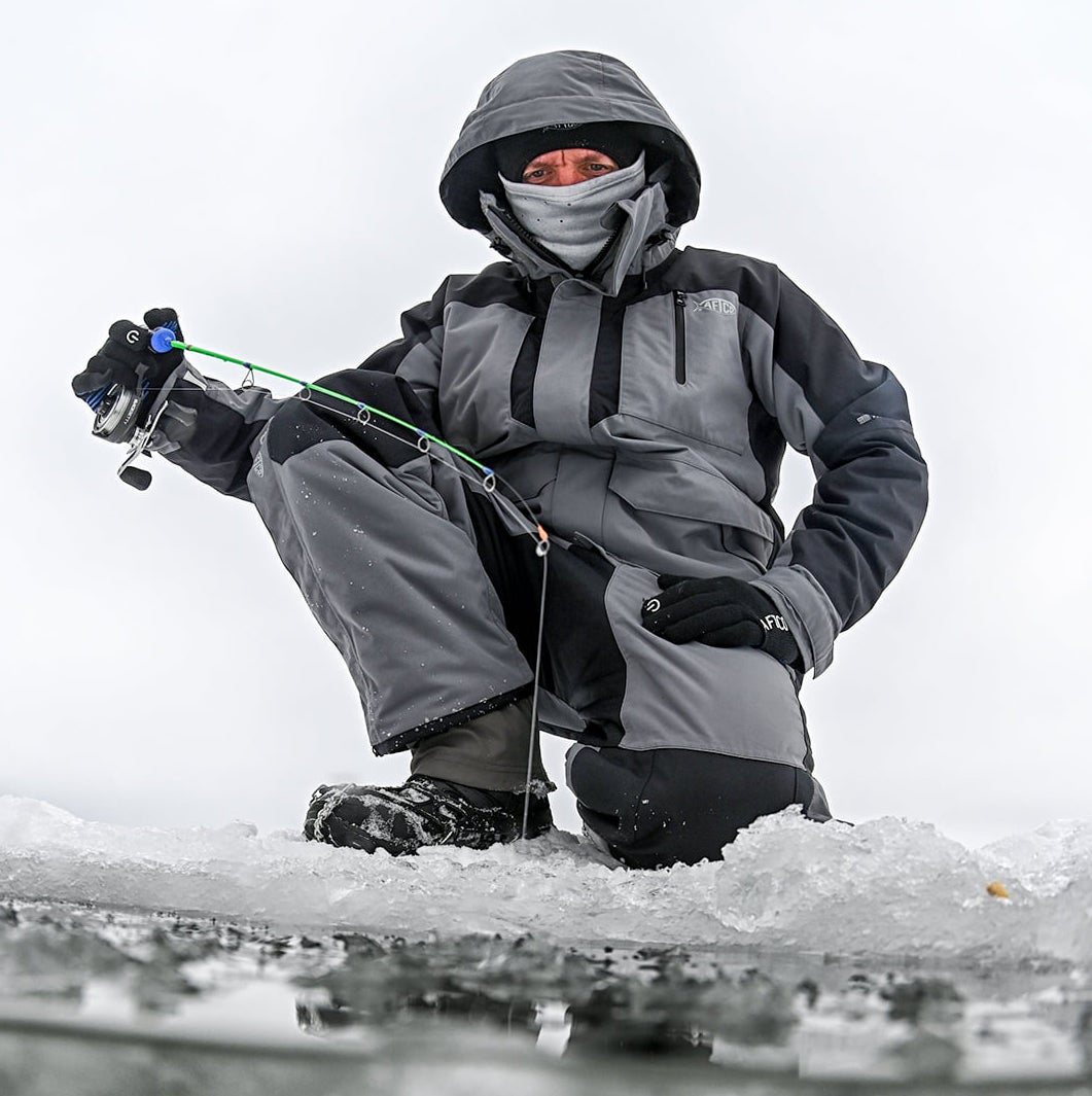 Angler wearing Aftco Hydonaut Insulated Bibs while ice fishing