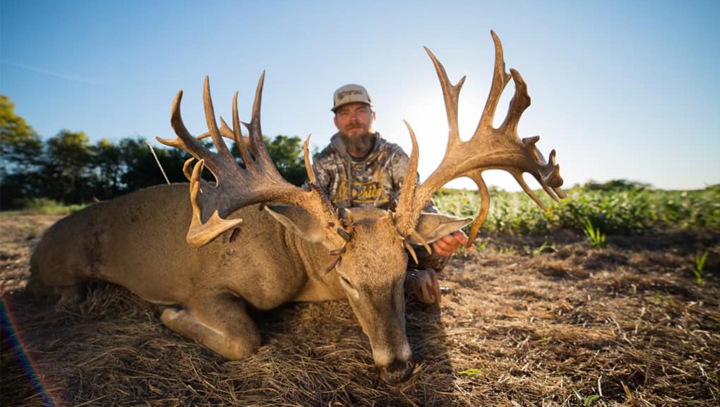 photo of hunter with trophy buck