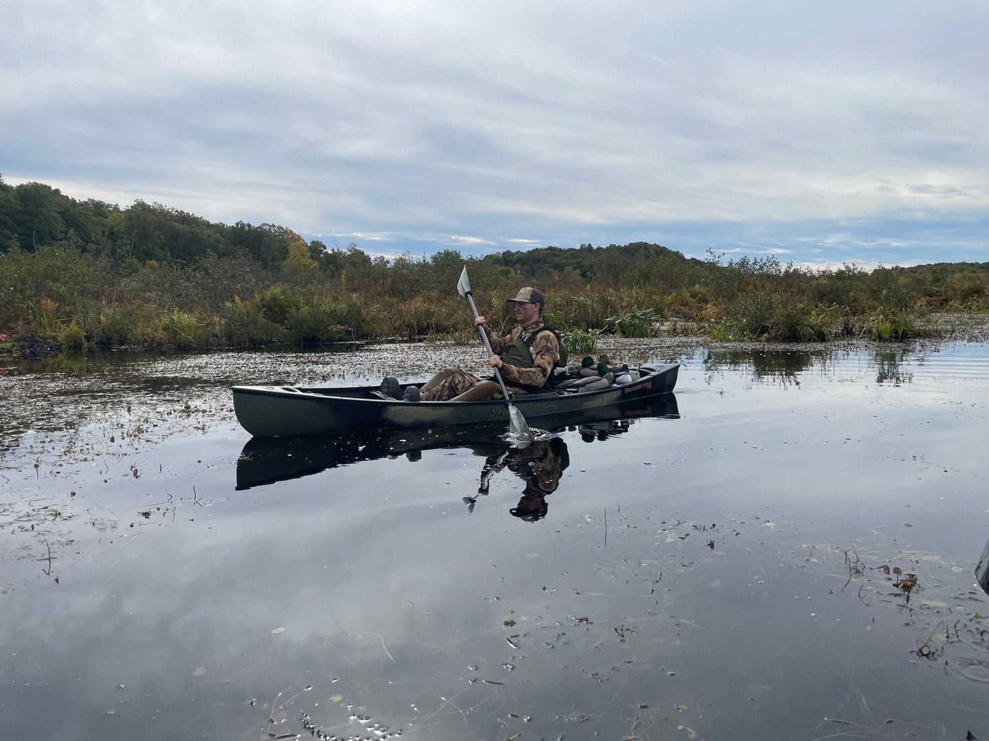 hunter paddling canoe