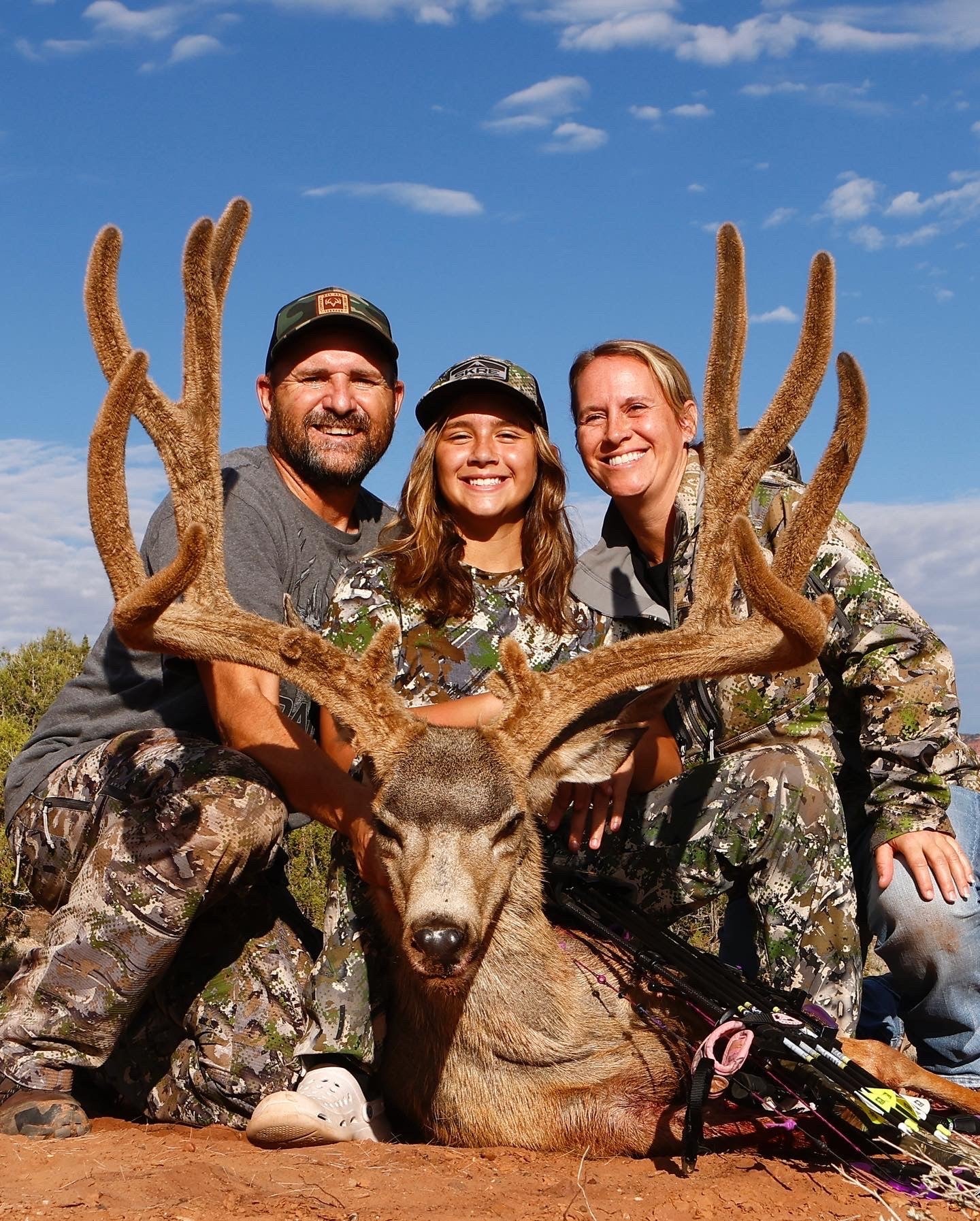 family photo with huge mule deer