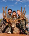 photo of family with huge mule deer buck