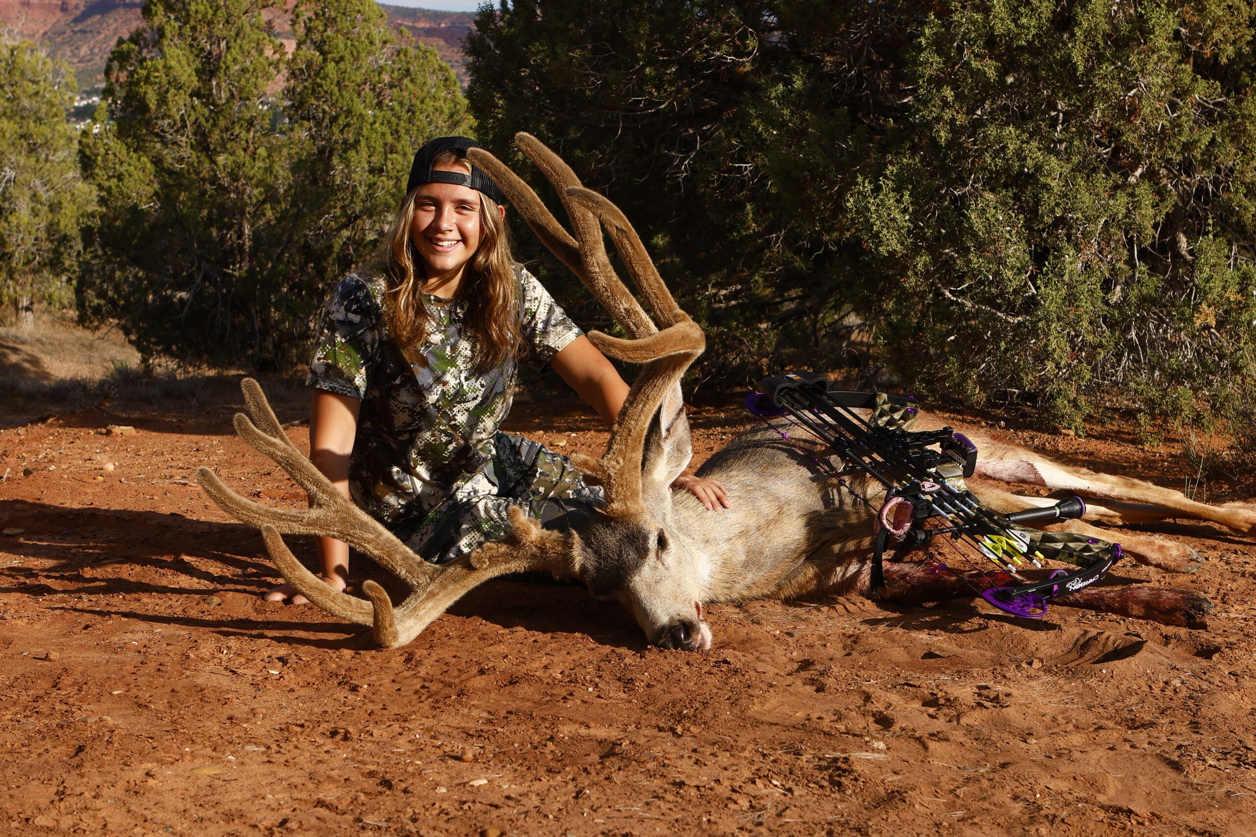 photo of girl with big mule deer buck