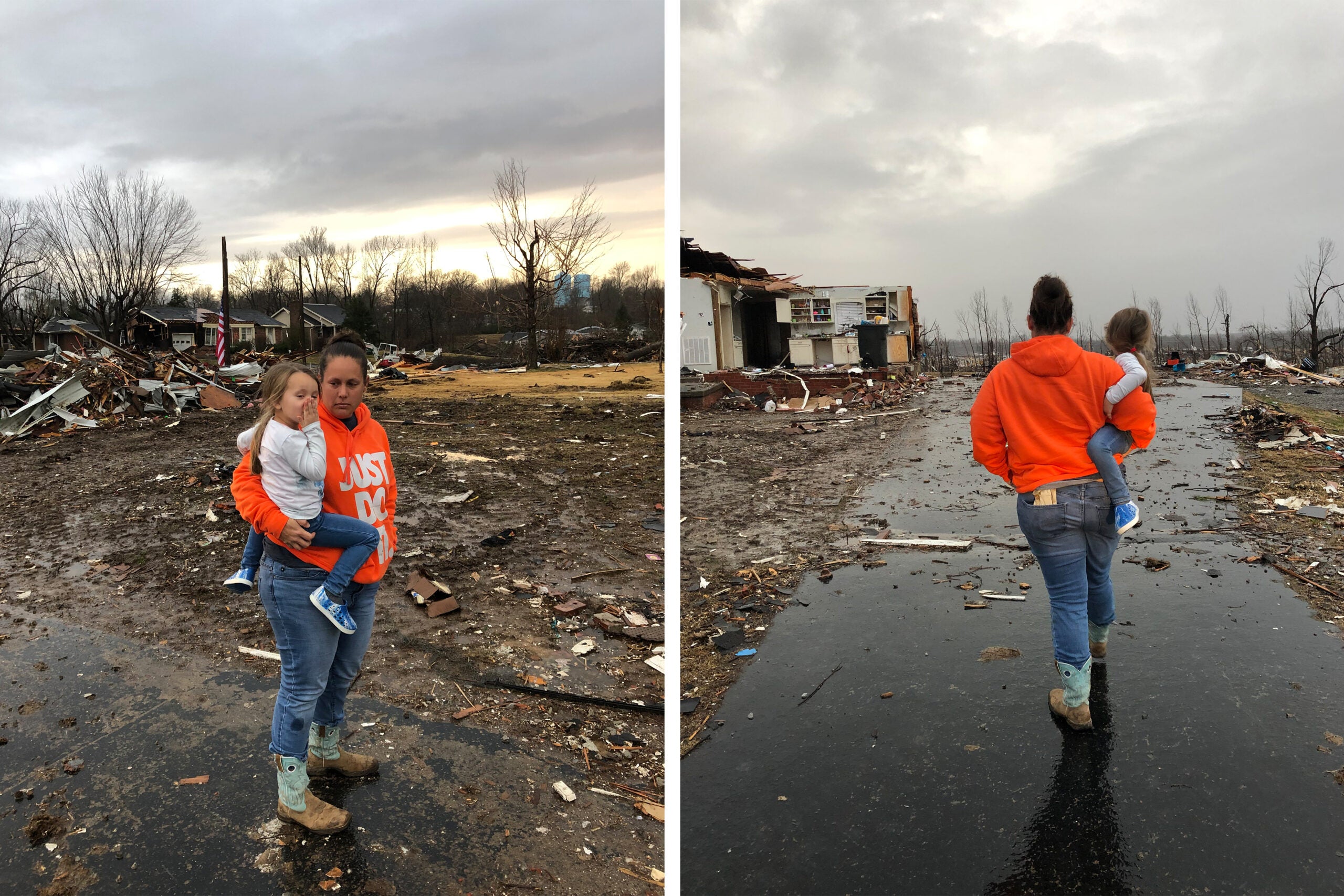 Woman walks through rubble with daughter.
