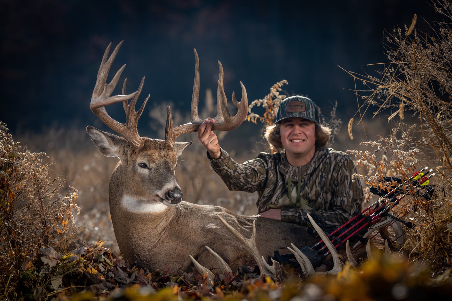hunter poses with buck with large rack
