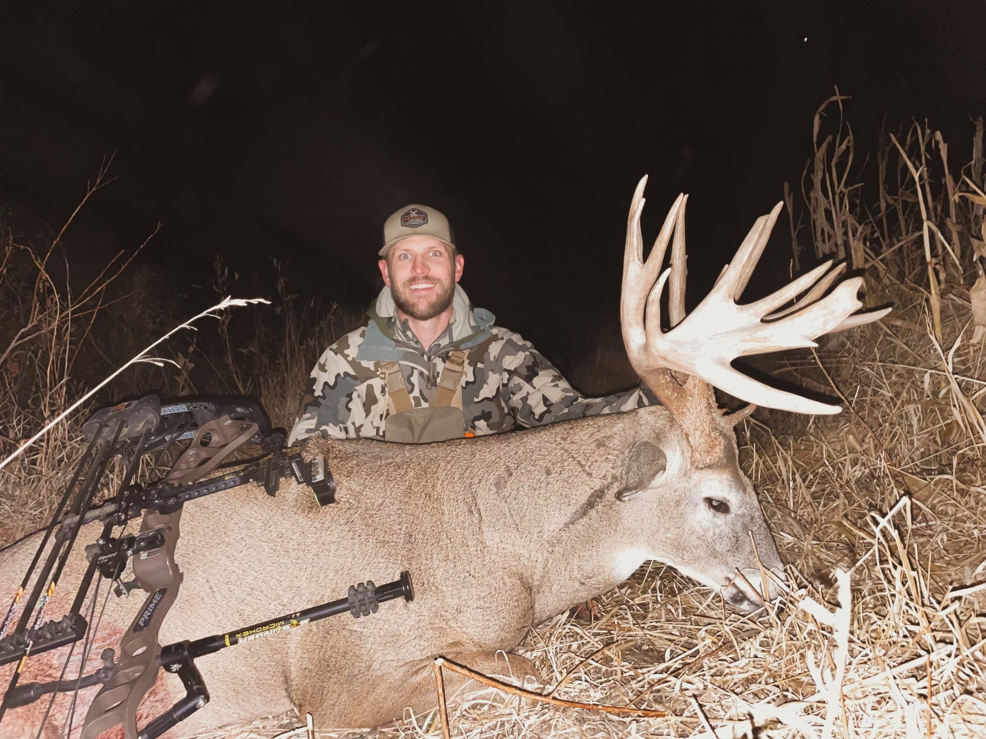 hunter poses with buck with large antlers