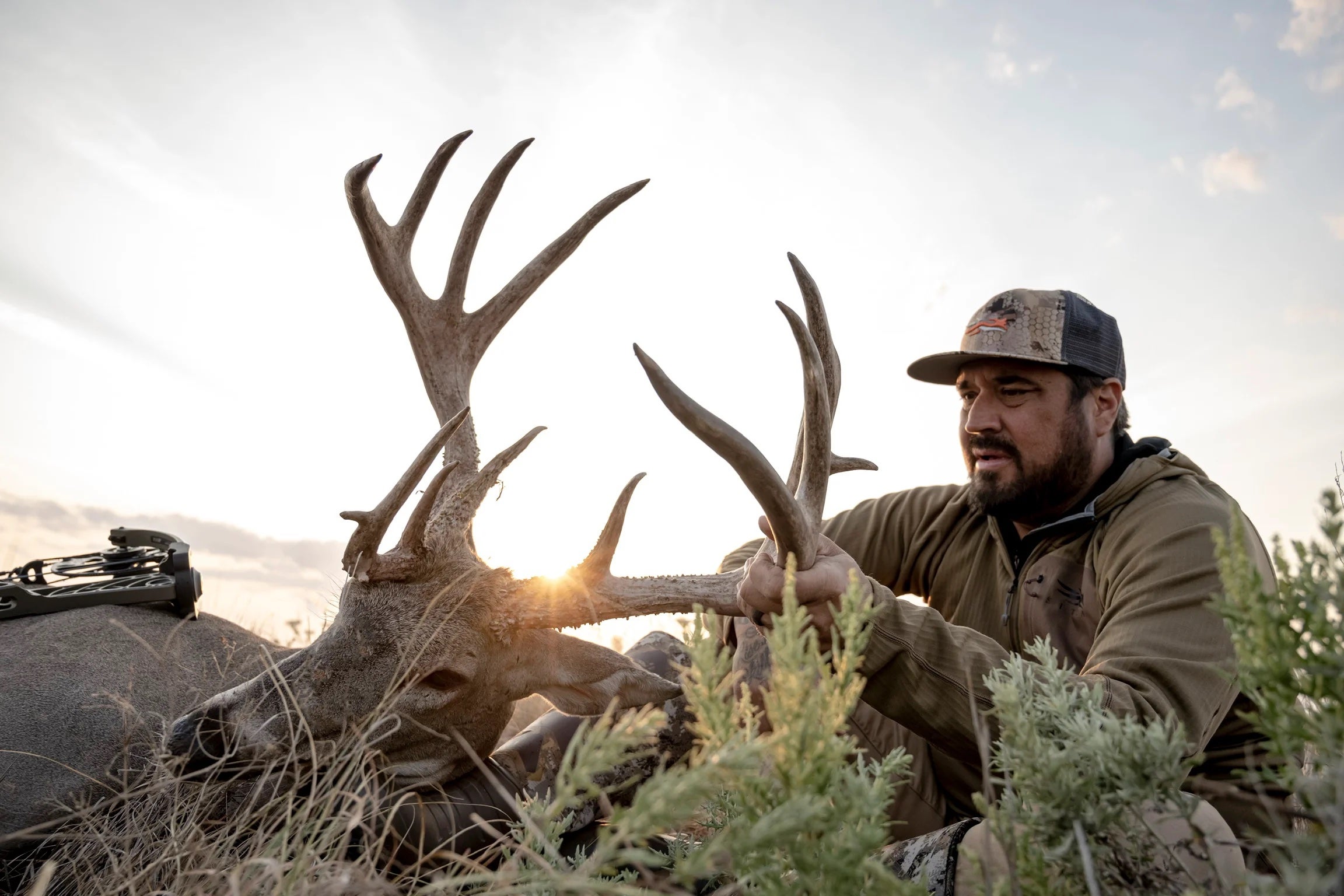 Hunter with whitetail deer shows that Kansas is one of the best deer hunting states