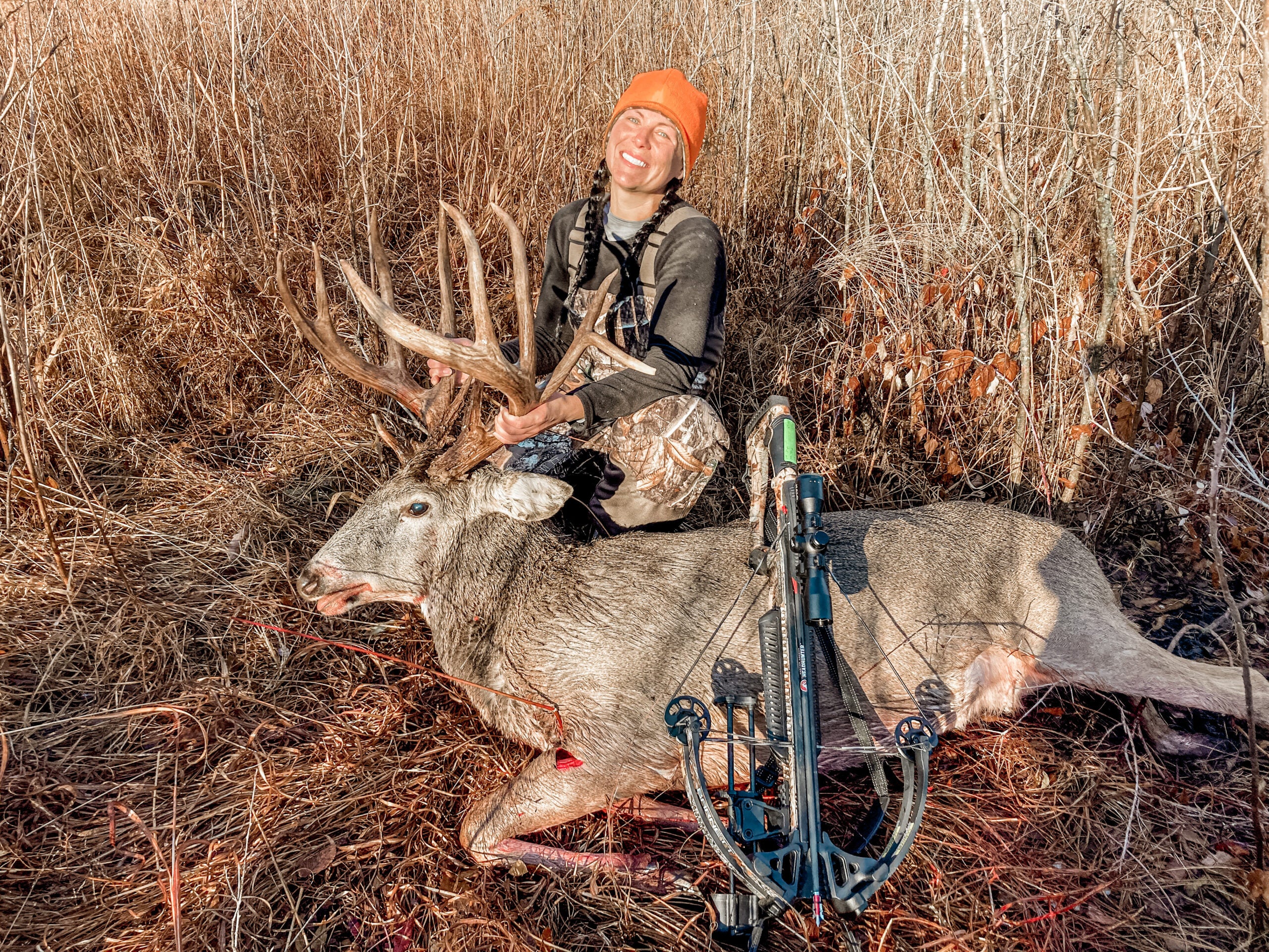 woman hunter poses with deer with big rack