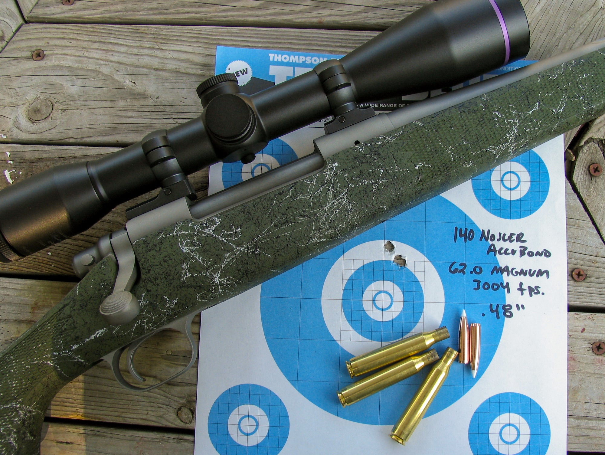 Rifle next to a target with .270 Winchester ammo.
