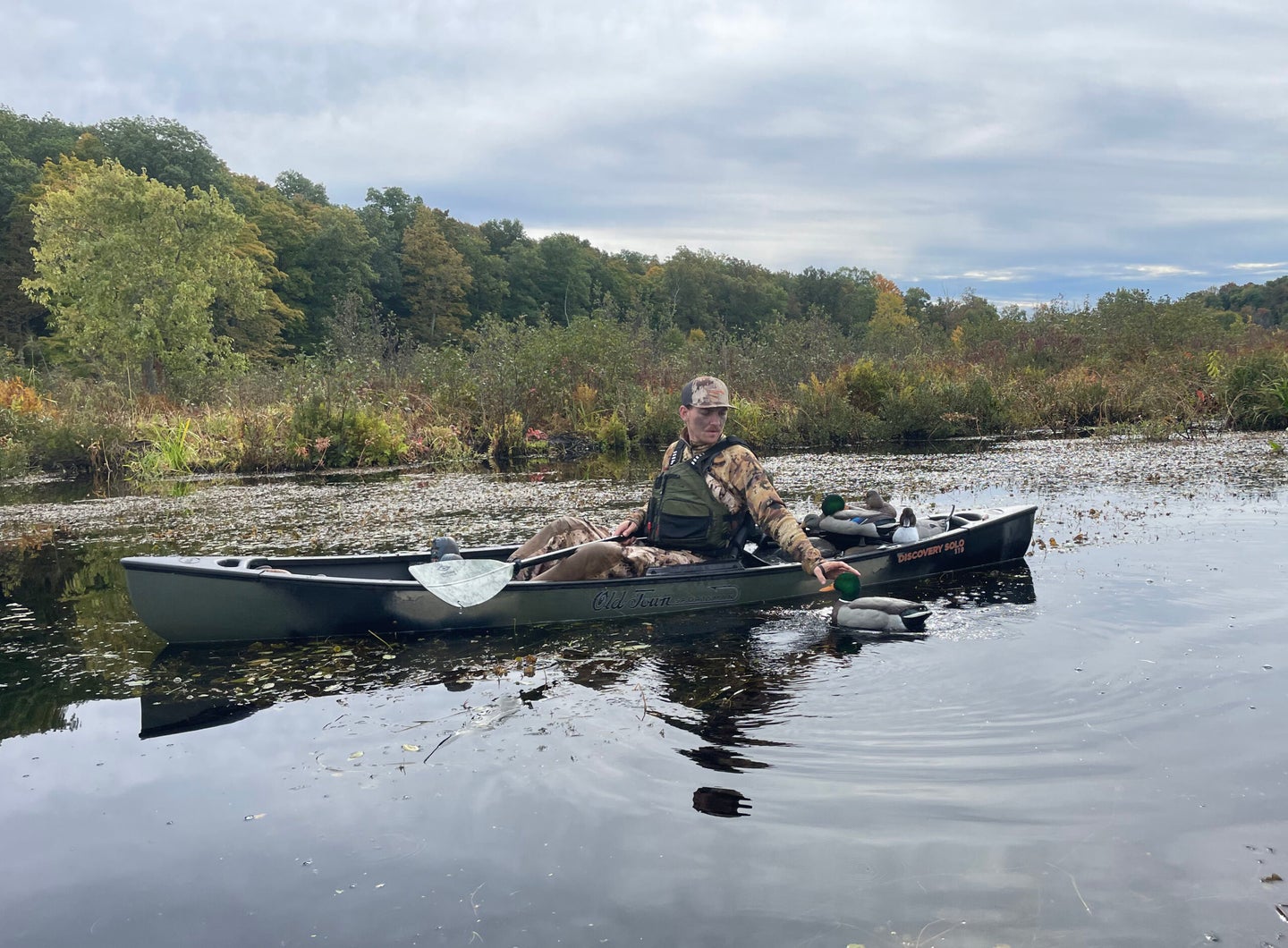 hunter picking up decoys from kayak