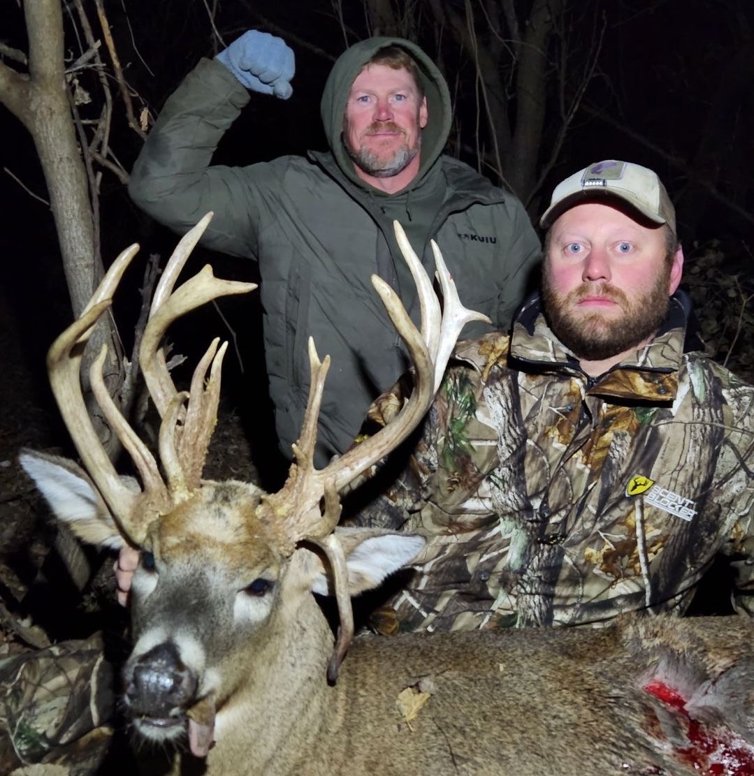 photo of hunters with buck
