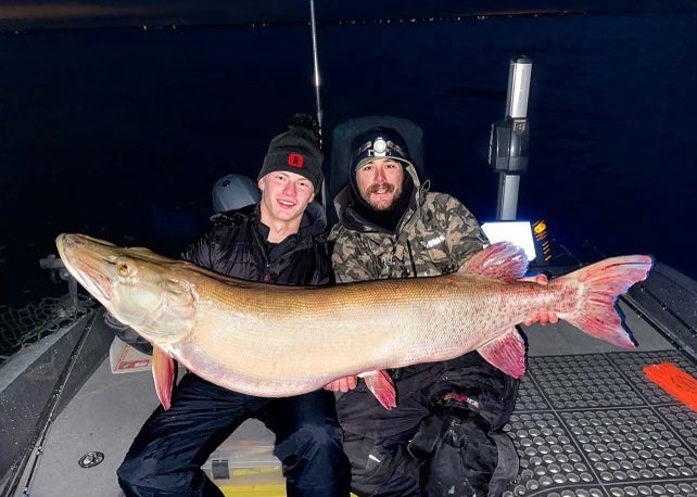 fishermen pose with giant muskie
