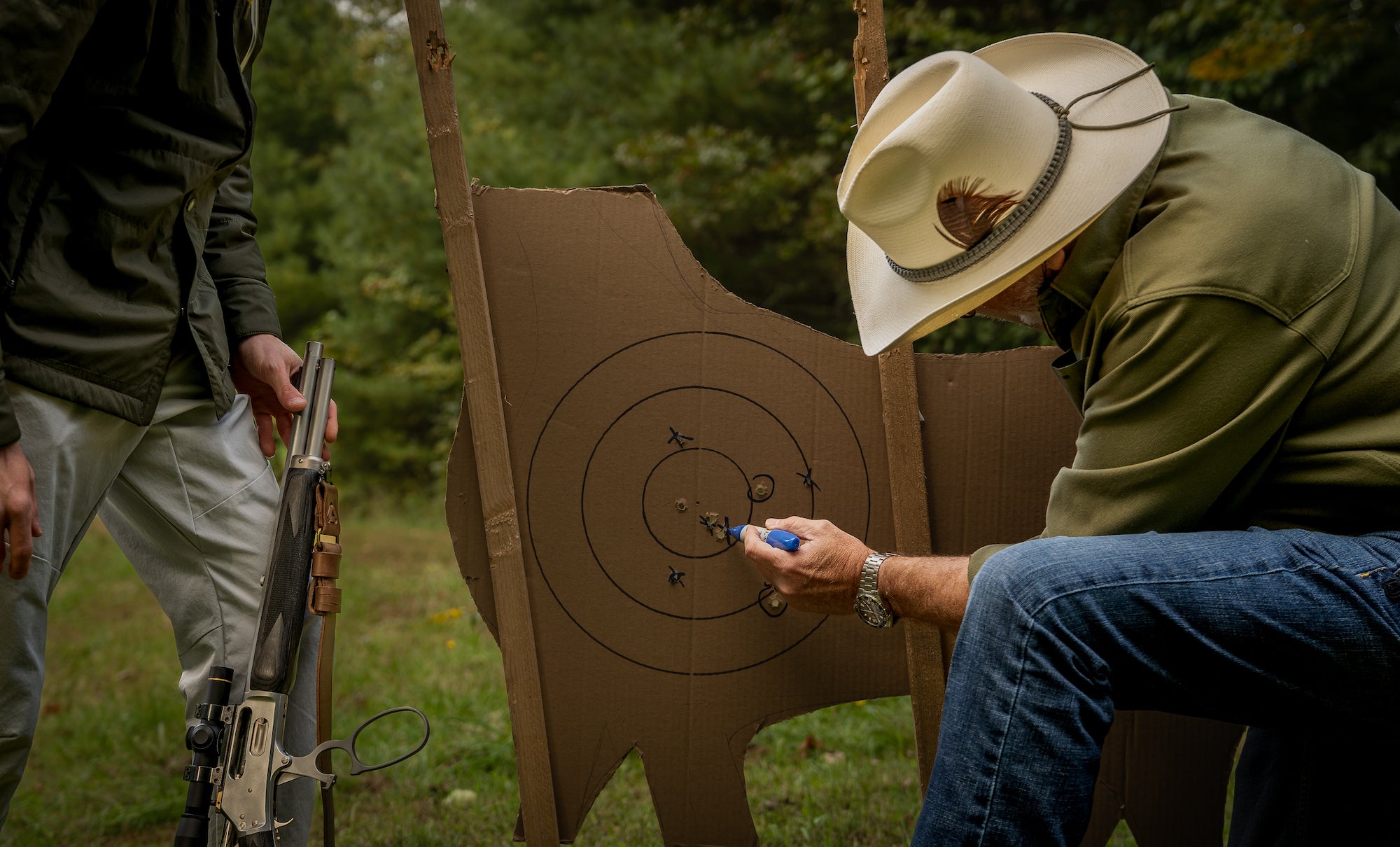 Man marking a target with a rifle.