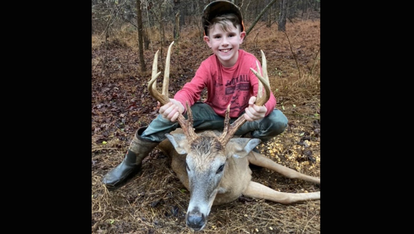 hunter with whitetail deer