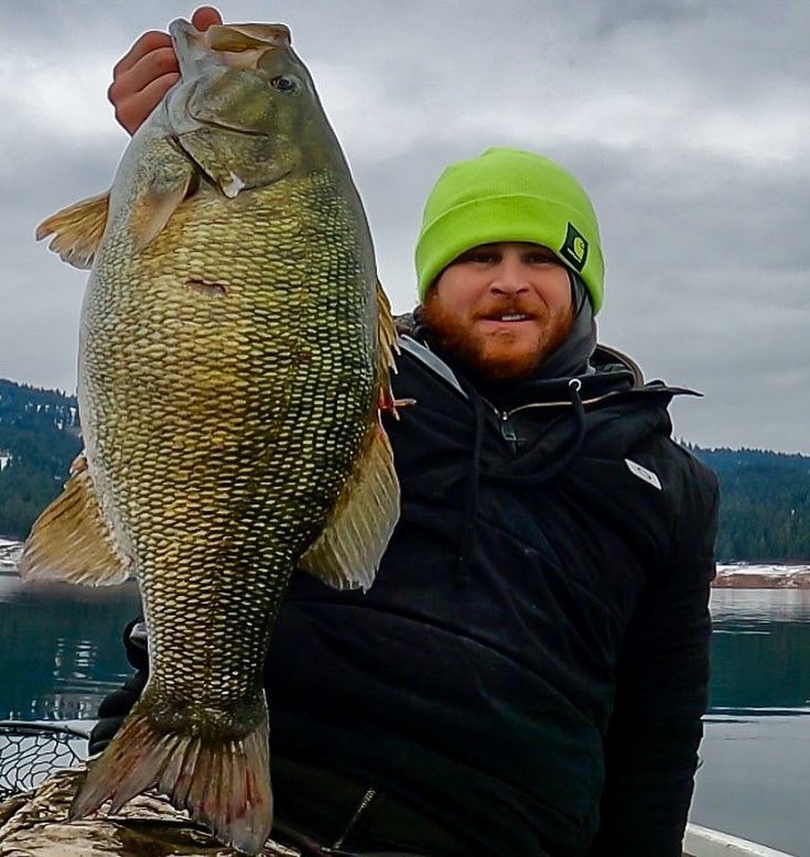 angler holds large smallmouth bass