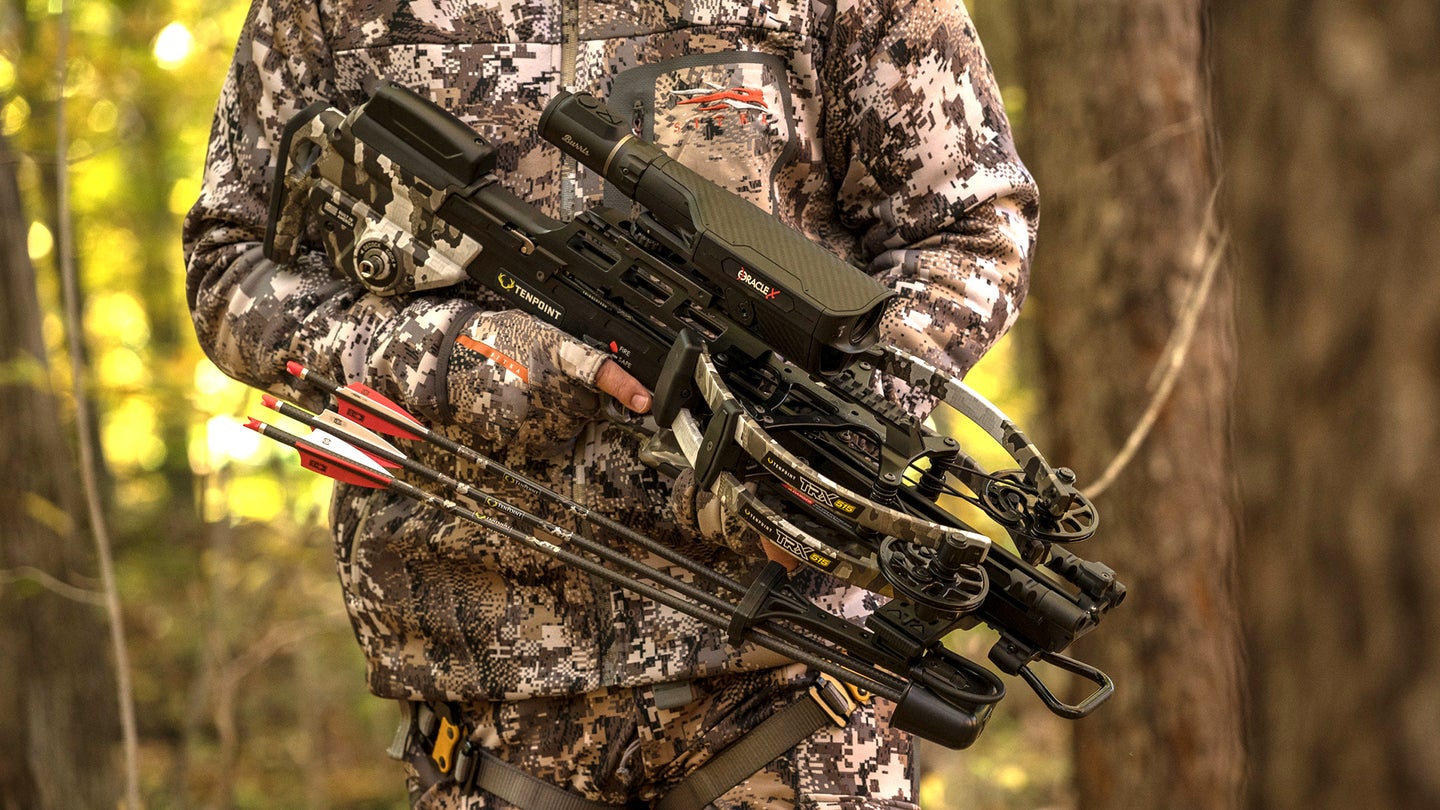 Hunter holds new TenPoint TRX 515 with woods in background