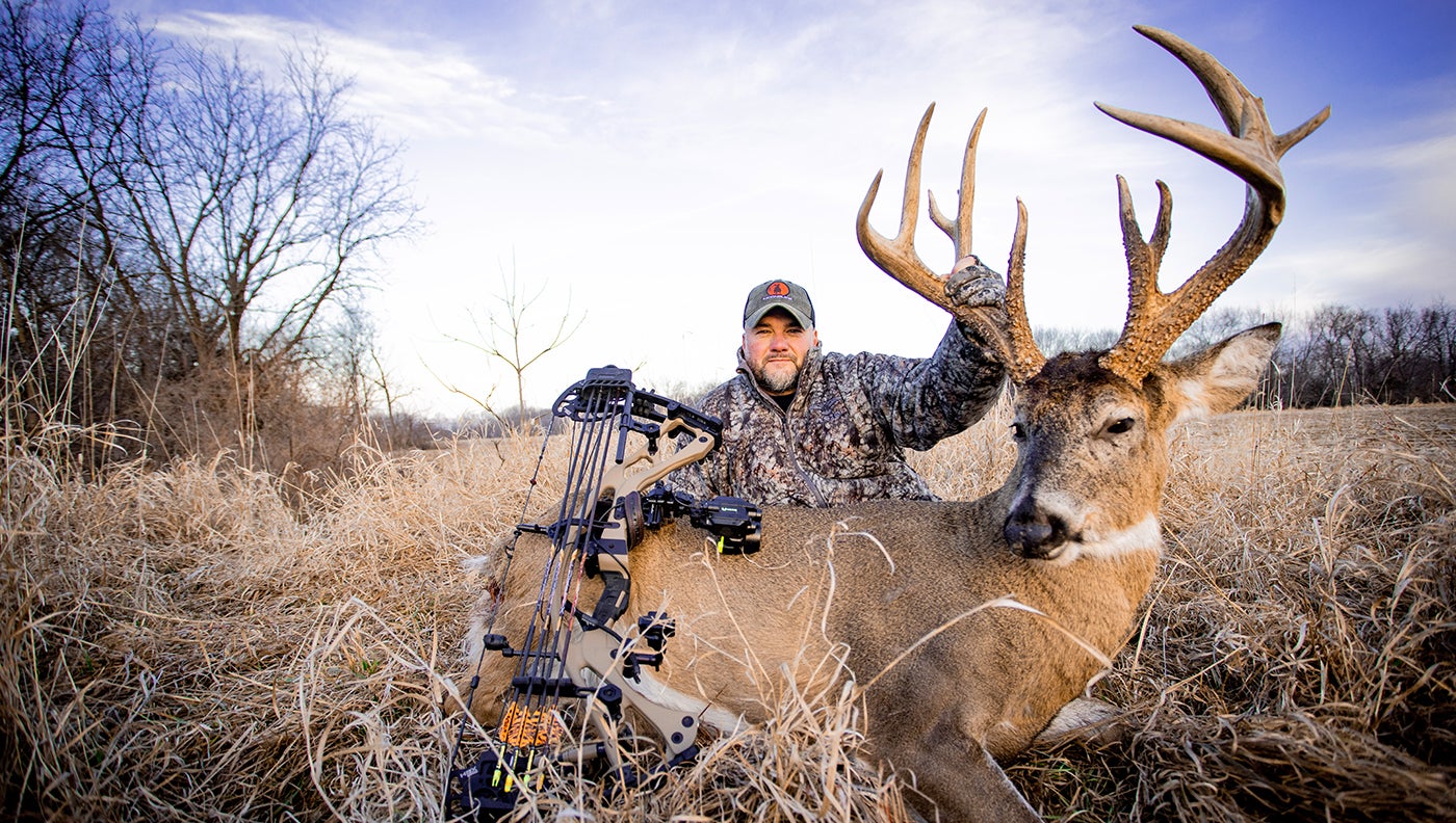 photo of hunter with red moon buck