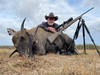 Hunter with Mossberg Patriot rifle next to dead nilgai