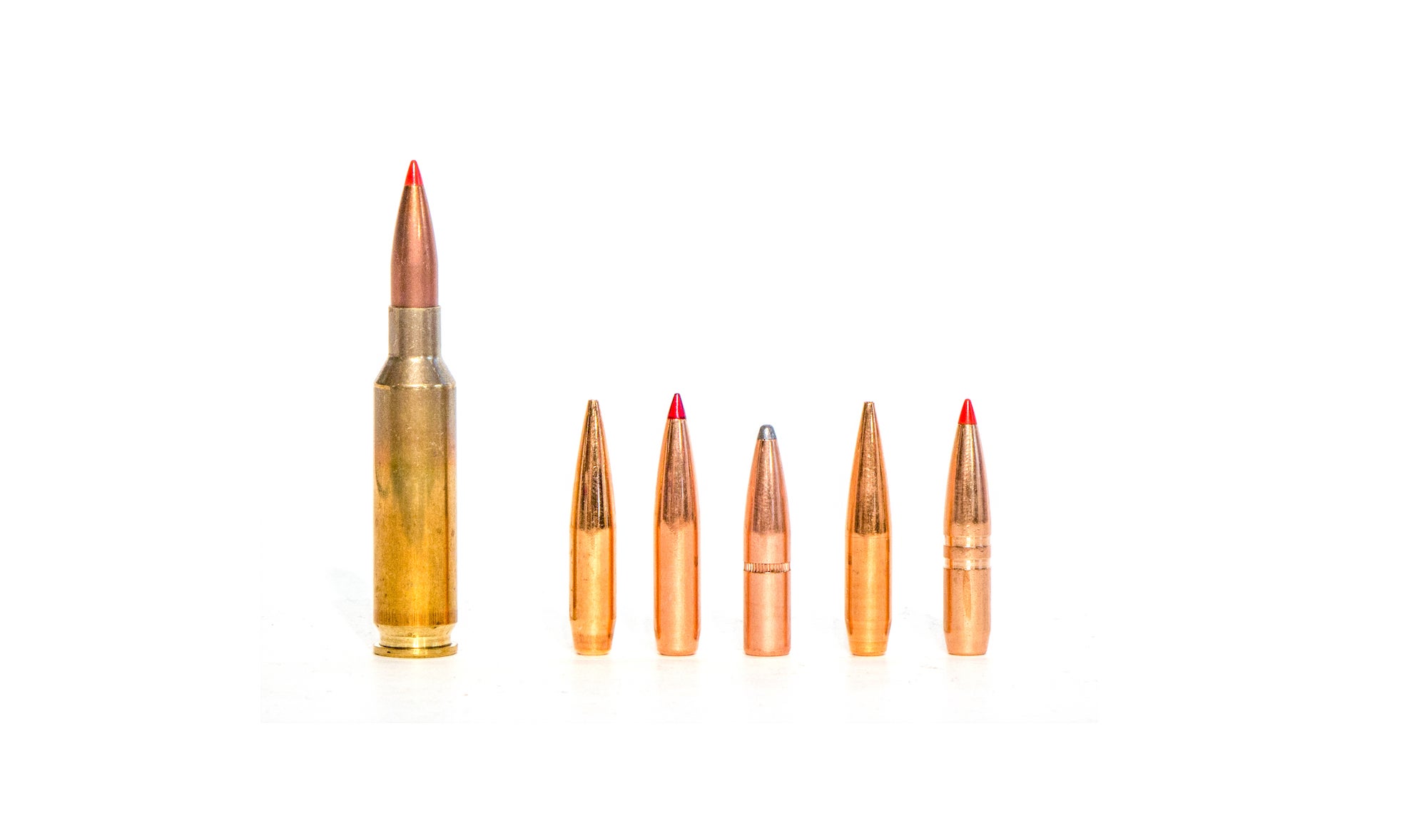 6.5 Creedmoor cartridge next to bullets.