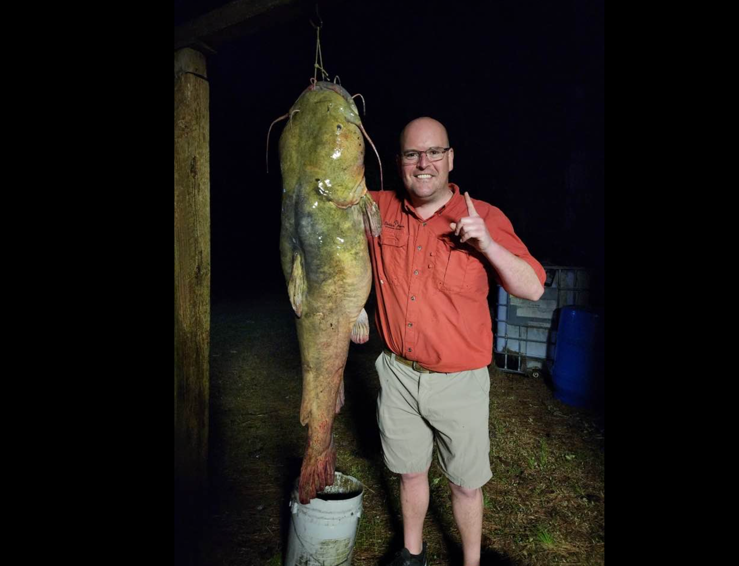 Man holding large flathead catfish