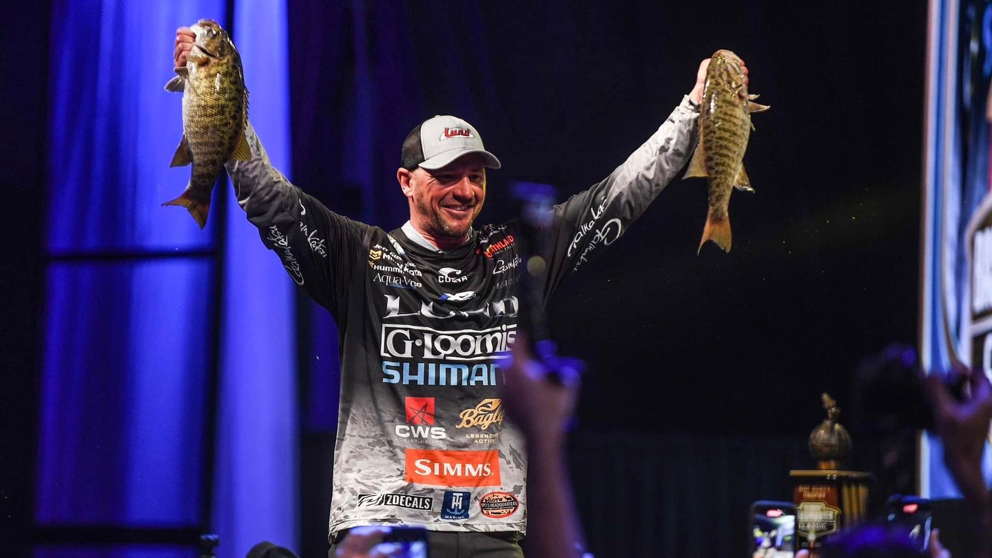 Jeff ‘Gussy’ Gustafson standing with two fish at the Bassmaster Classic.