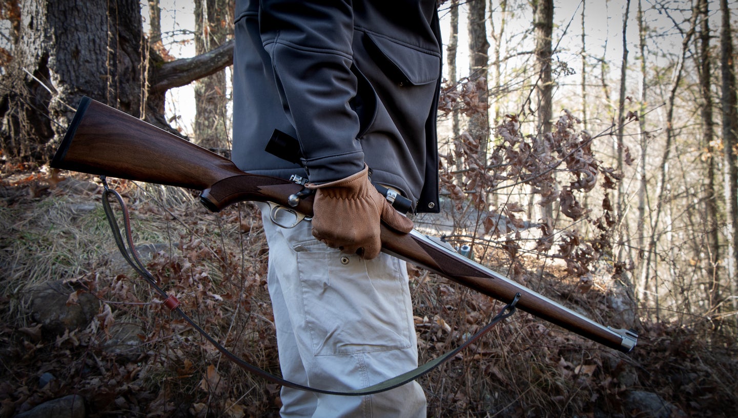 Man holding a hunting rifle.