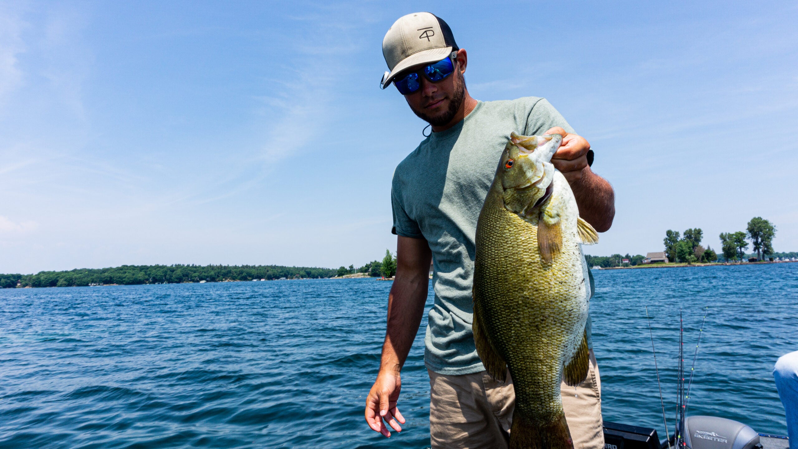 angler holds big smallmouth bass