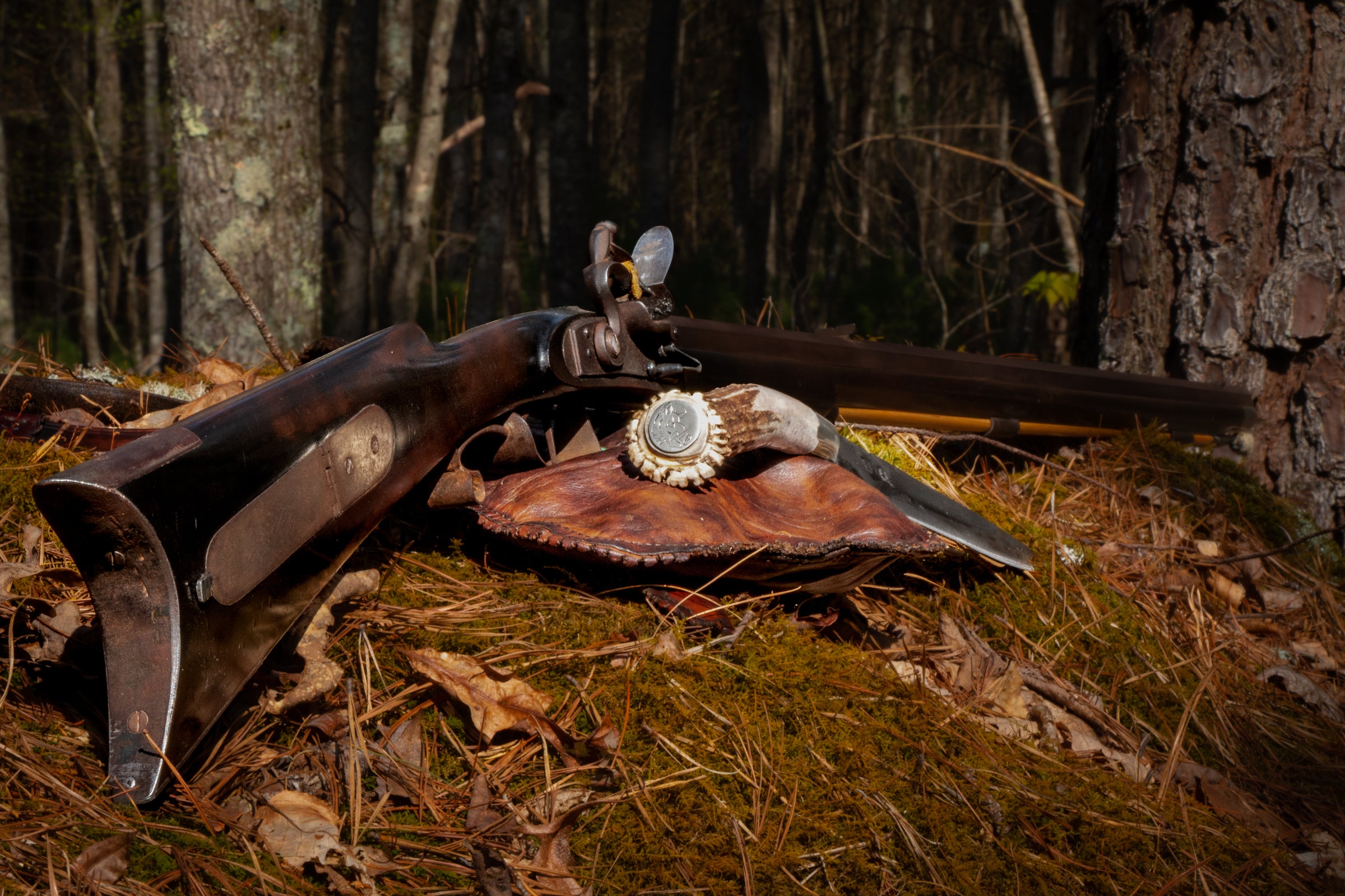 A traditional hunter's kit on the floor of the woods.